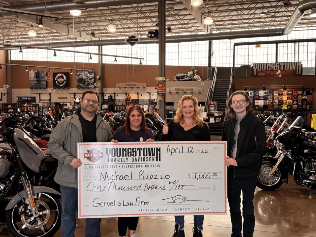 Gervelis team posing with check with Youngstown Harley Davidson team