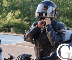 Motorcyclist putting on a helmet