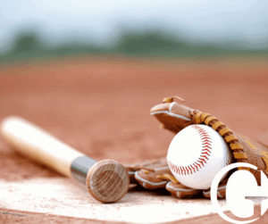 Baseball gloves and bat on field