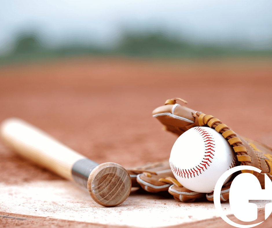 Baseball gloves and bat on field