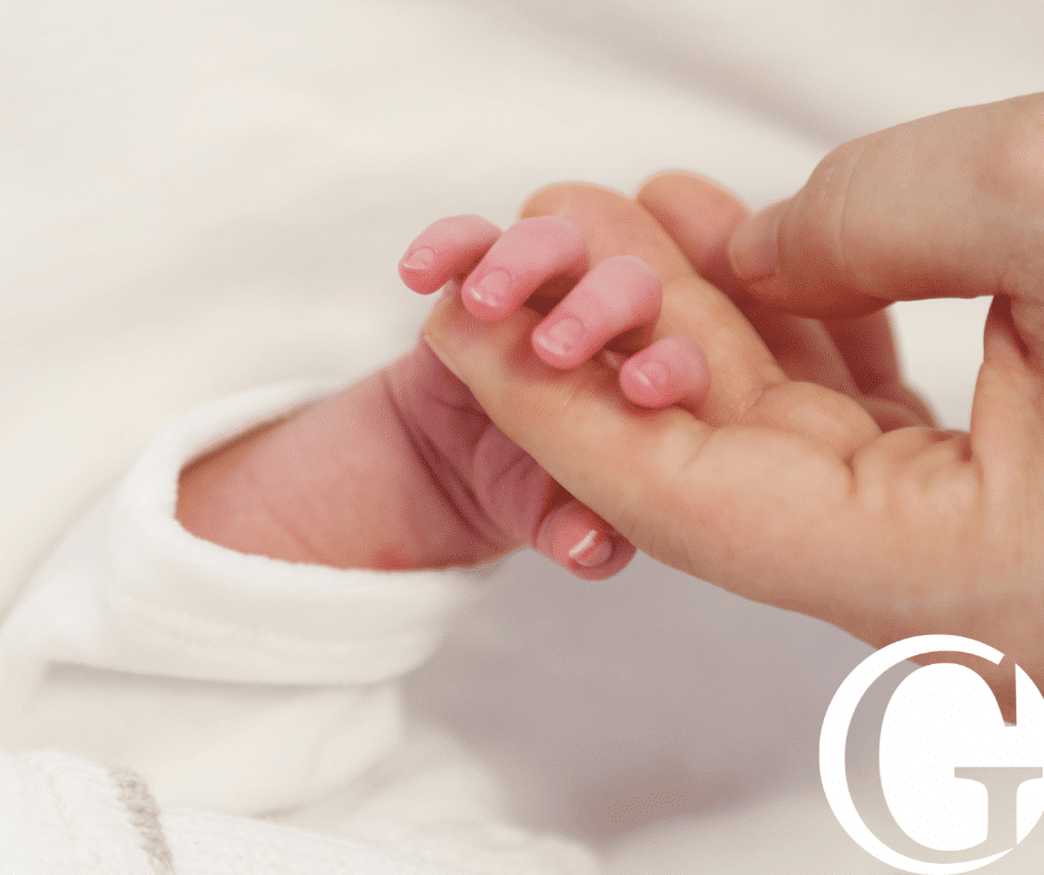Closeup of mother holding a baby's hand